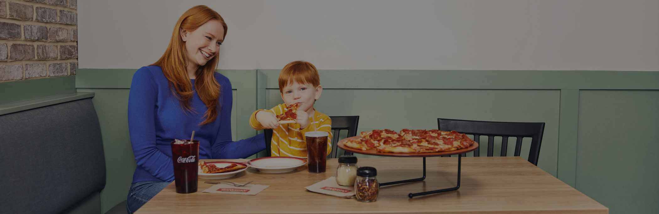 A mom and son enjoying a LaRosa's pizza.