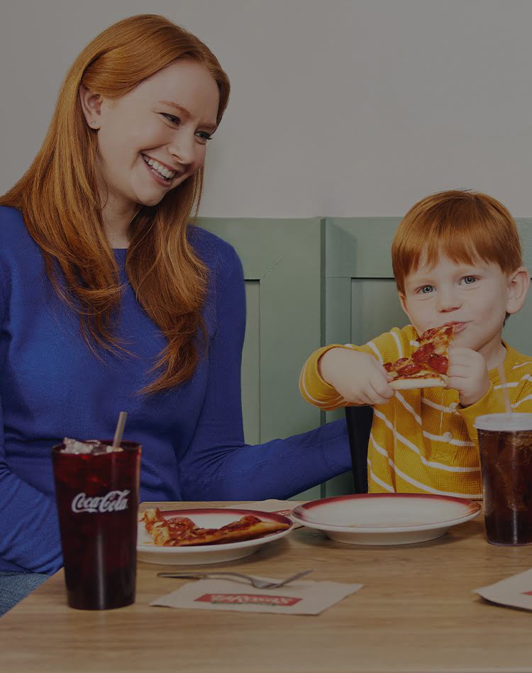 A mom and son enjoying a LaRosa's pizza.